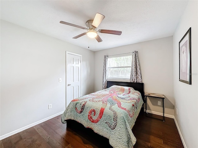 bedroom with ceiling fan and dark hardwood / wood-style flooring