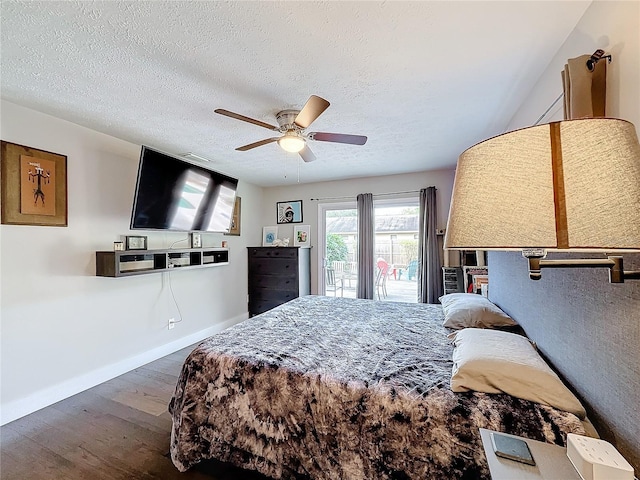 bedroom featuring ceiling fan, dark hardwood / wood-style flooring, and a textured ceiling