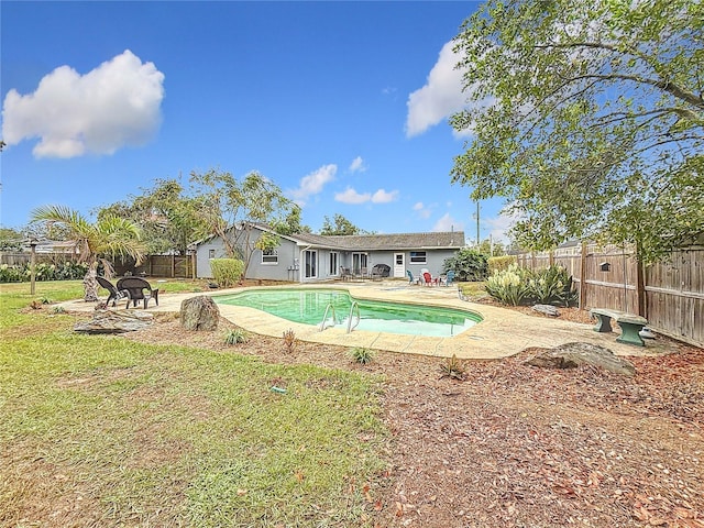 view of swimming pool featuring a patio and a lawn