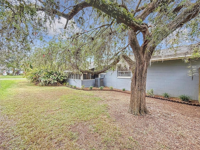 view of yard with a sunroom and cooling unit