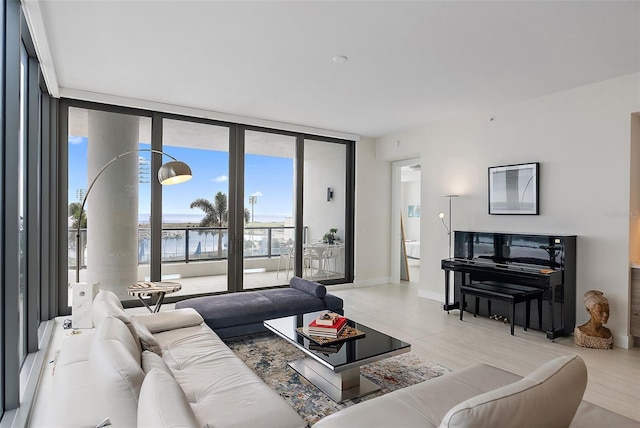 living room featuring expansive windows and a water view