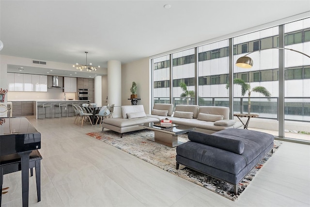 living room featuring floor to ceiling windows, sink, and an inviting chandelier