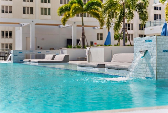 view of swimming pool featuring a patio area and pool water feature