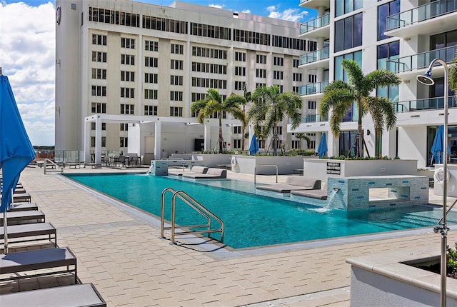 view of swimming pool with a patio area and pool water feature