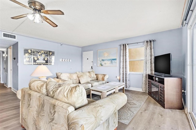 living room with ceiling fan and light wood-type flooring