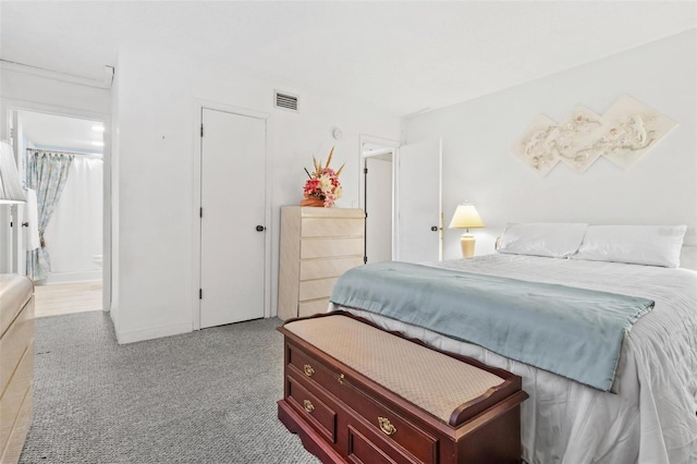 carpeted bedroom with connected bathroom