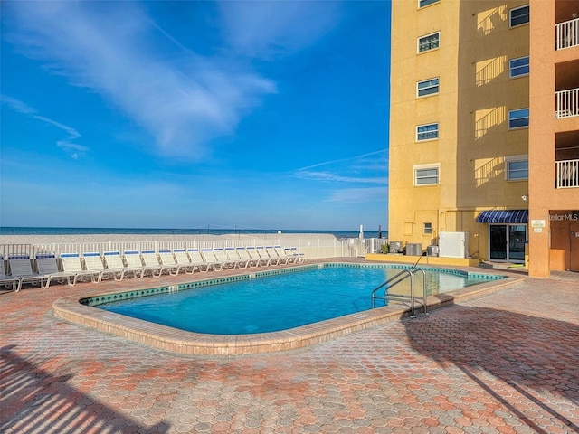 view of swimming pool featuring a water view