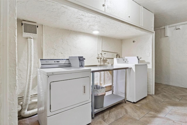 washroom with cabinets and independent washer and dryer