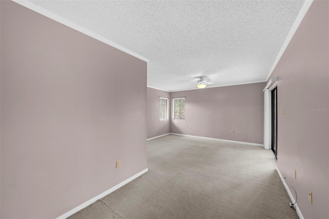 carpeted spare room with crown molding, a textured ceiling, and ceiling fan