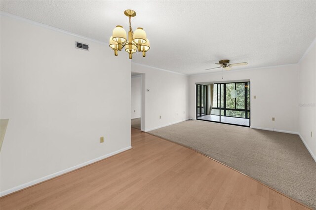 2679 Sabal Springs Cir Unit 203, Clearwater, FL 33761 - empty room featuring crown molding, ceiling fan with notable chandelier, light hardwood / wood-style flooring, and a textured ceiling