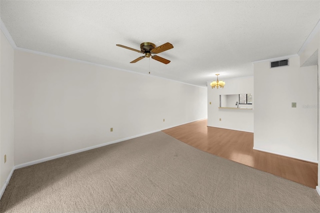 2679 Sabal Springs Cir Unit 203, Clearwater, FL 33761 - carpeted spare room featuring crown molding, ceiling fan with notable chandelier, and a textured ceiling