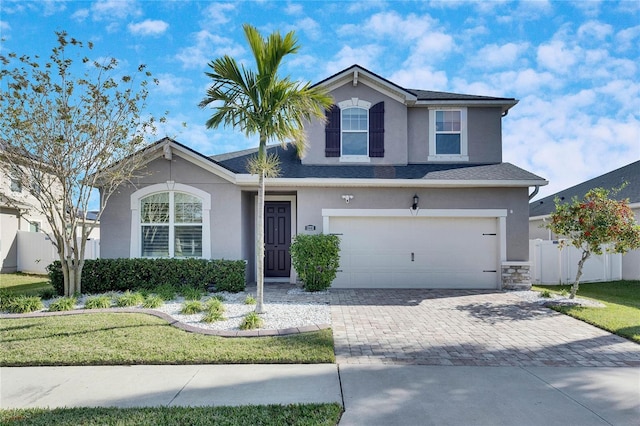 view of front of home with a front yard and a garage