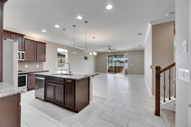 kitchen with sink, stainless steel appliances, an island with sink, ceiling fan, and dark brown cabinetry