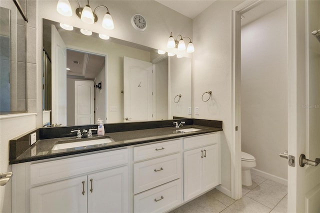 bathroom with vanity, tile patterned floors, and toilet