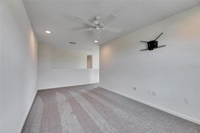 carpeted empty room featuring a textured ceiling and ceiling fan