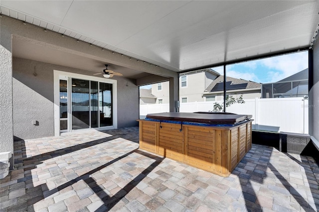 sunroom / solarium with ceiling fan and a jacuzzi