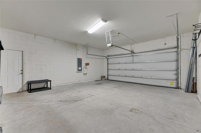 garage featuring electric panel and a garage door opener