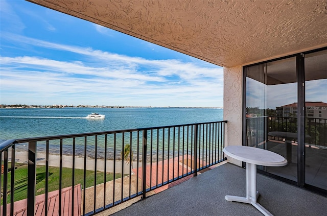 balcony featuring a water view