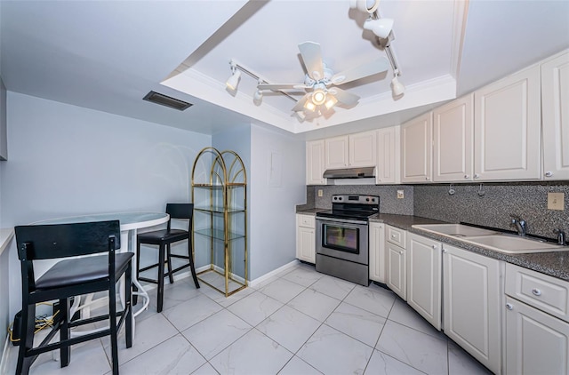 kitchen featuring electric range, a raised ceiling, white cabinetry, and sink