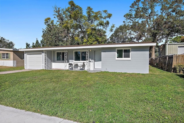 single story home featuring a garage, a porch, and a front yard