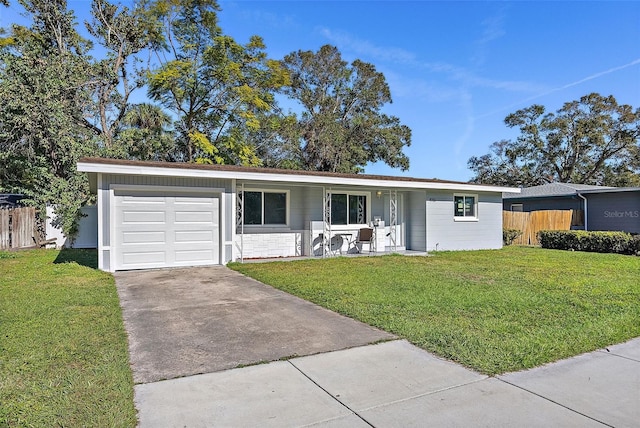 single story home with covered porch, a garage, and a front lawn