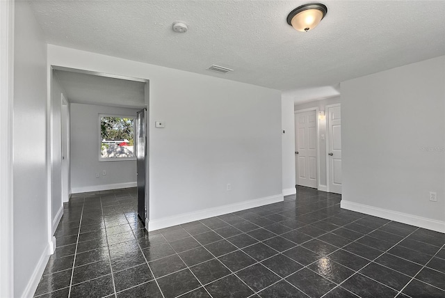 empty room featuring a textured ceiling