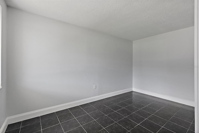 unfurnished room with a textured ceiling