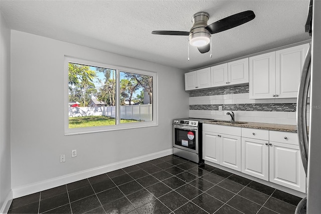 kitchen with decorative backsplash, ceiling fan, white cabinetry, and sink