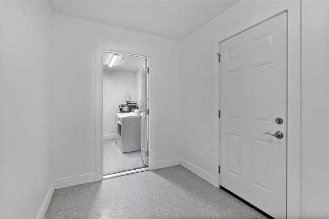 corridor with washing machine and dryer