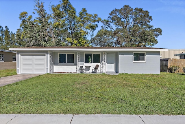 ranch-style home featuring driveway, an attached garage, a front yard, and fence