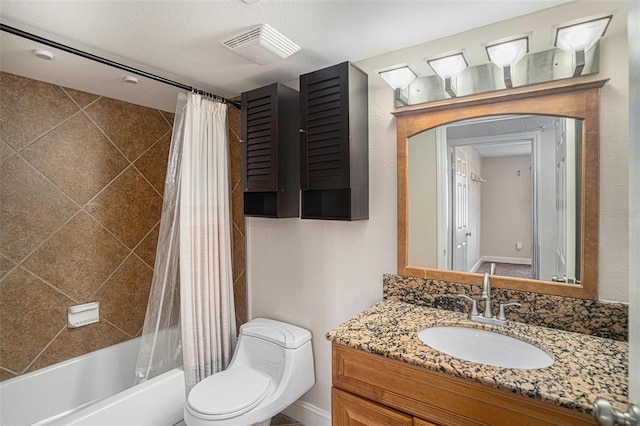 full bathroom featuring a textured ceiling, vanity, toilet, and shower / tub combo with curtain