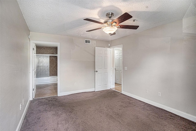 unfurnished bedroom featuring carpet, a textured ceiling, and ceiling fan