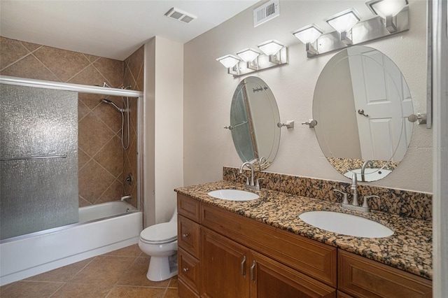 full bathroom featuring tile patterned floors, toilet, vanity, and combined bath / shower with glass door