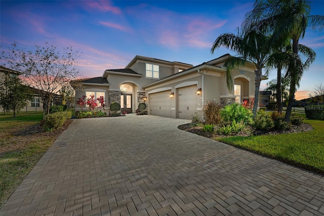 view of front of home with a garage and a yard