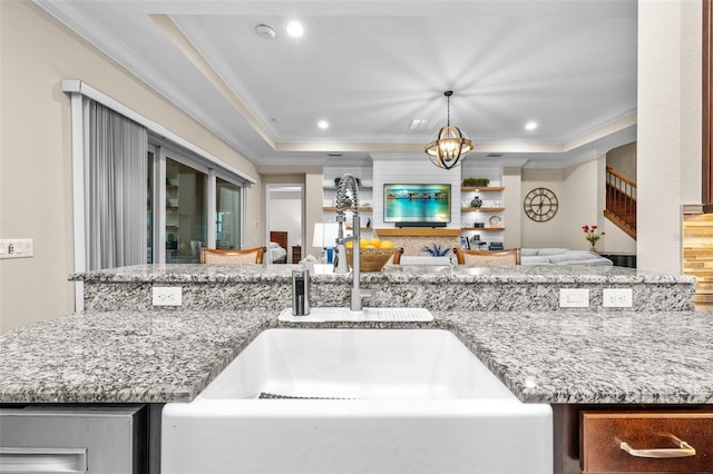 kitchen featuring sink, pendant lighting, a tray ceiling, and ornamental molding