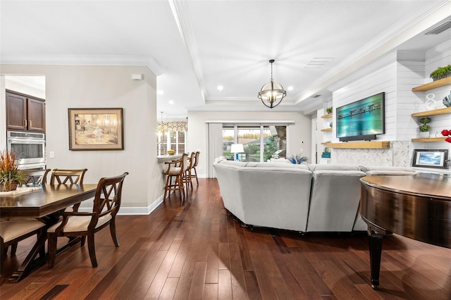 living room with crown molding, dark hardwood / wood-style floors, and a notable chandelier