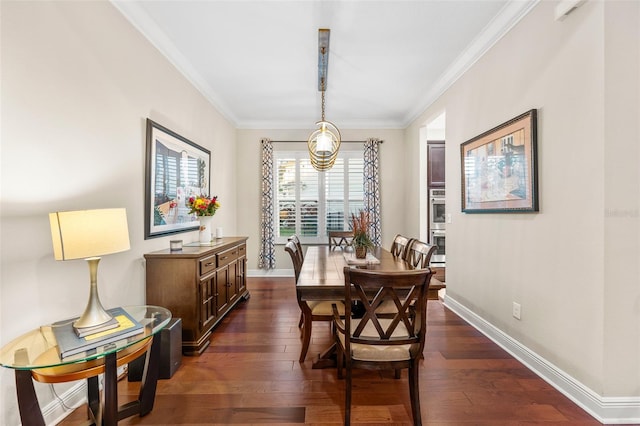 dining area featuring dark wood-type flooring and crown molding