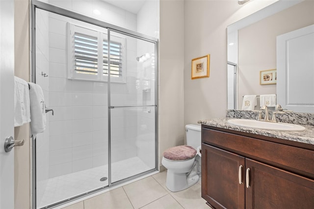 bathroom featuring toilet, tile patterned flooring, walk in shower, and vanity