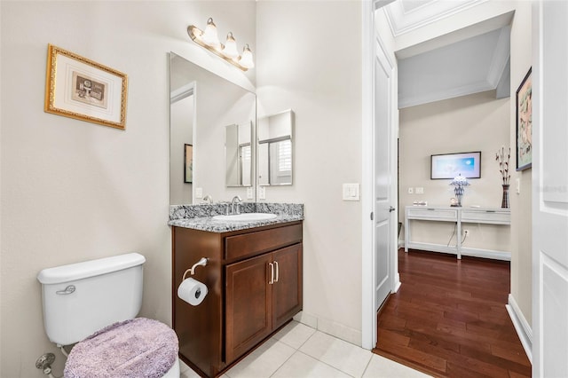 bathroom featuring toilet, tile patterned flooring, crown molding, and vanity