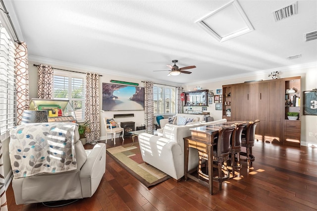 living room with ceiling fan, a textured ceiling, dark hardwood / wood-style floors, and crown molding