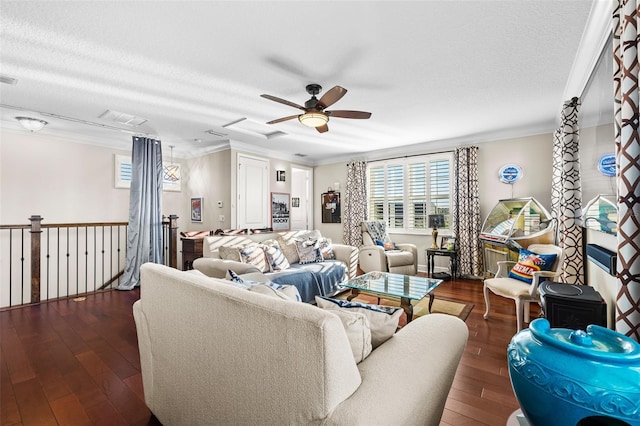 living room with ceiling fan, dark hardwood / wood-style flooring, ornamental molding, and a textured ceiling