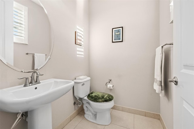 bathroom featuring toilet, tile patterned floors, and sink