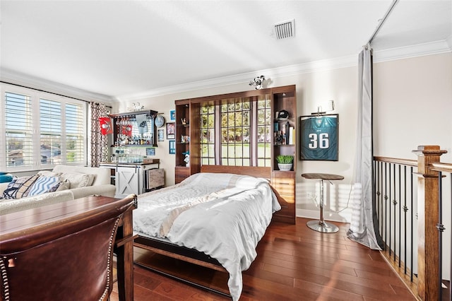 bedroom featuring dark hardwood / wood-style floors and ornamental molding