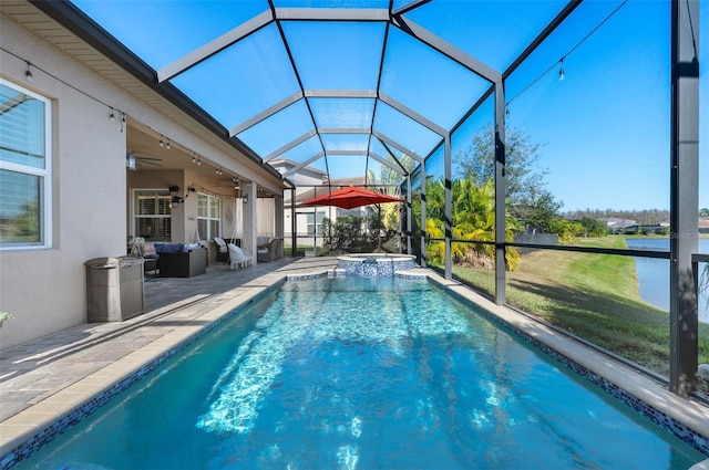 view of pool with a lanai, ceiling fan, an in ground hot tub, and a patio