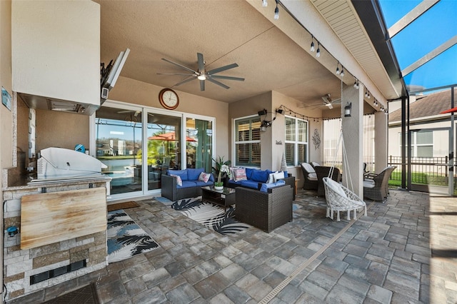 view of patio featuring an outdoor hangout area, ceiling fan, area for grilling, and a lanai