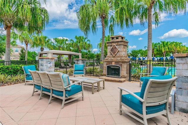 view of patio with an outdoor stone fireplace