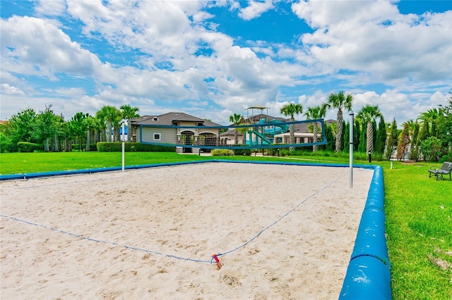 view of community featuring volleyball court and a yard