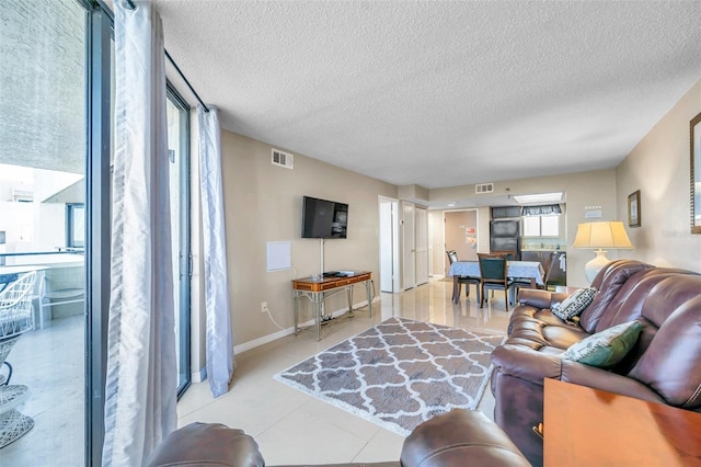 living room with light tile patterned floors and a textured ceiling