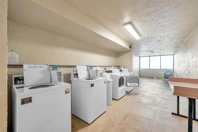 laundry room featuring light tile patterned floors and washing machine and clothes dryer