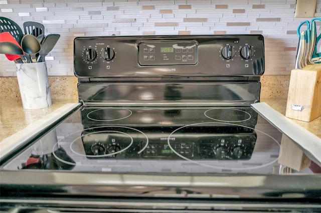 room details with backsplash and black range with electric stovetop